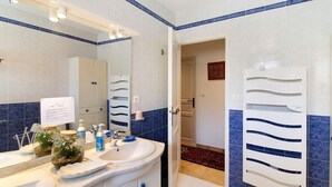 A bathroom with a white sink, mirror, and blue-tiled walls. - Sea and Canopy Rooms: Mountain View, Shared Terrace and Garden (SARROLA CARCOPINO)