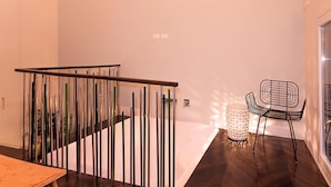 A modern interior with a staircase, a dining area, and a seating space. - Huge design apartment in the center of Venice, with private courtyard (Venezia)