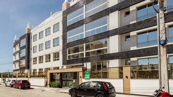 A multi-story building with a modern design, featuring large windows and a flat roof.