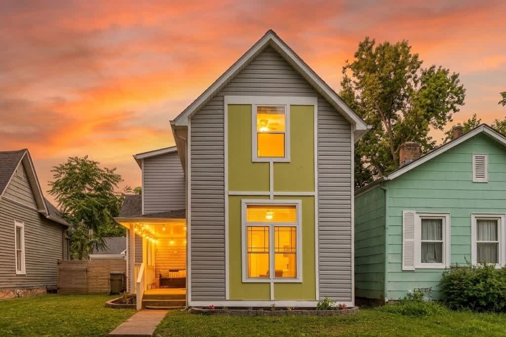 A two-story house with a front porch and a garage.