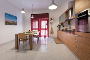 Full-sized fridge, oven, stovetop, cookware/dishes/utensils