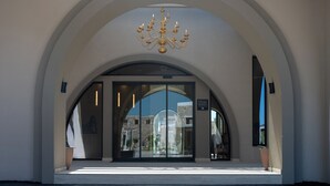 A hotel entrance with a large arched doorway, a chandelier, and a sign for 'SMART HOTELS'. - The Landmark Villas & Spa (Rhodes)