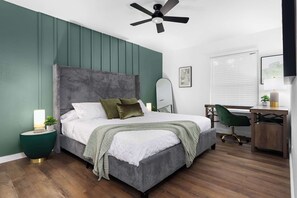 A bedroom with a bed, bedside table, desk, chair, and ceiling fan. - Premier Access to Zilker Park & South Congress (Austin)