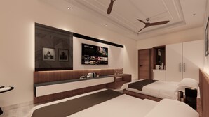 A modern hotel room with a large bed, a bedside table, a built-in TV, and a wardrobe. - Utkal Hotels Bhubaneswar (Bhubaneshwar)