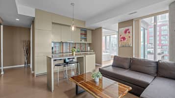Deluxe Apartment | Living area | 55-inch LED TV with cable channels