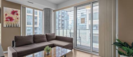 Deluxe Apartment | Living area | 55-inch LED TV with cable channels