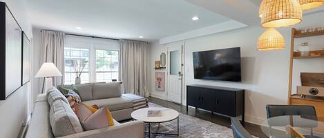 A modern living room with a sofa, coffee table, and TV.