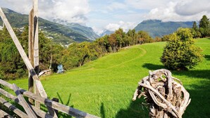 A rural landscape with a wooden fence, a grassy field, and mountains in the background. - Room 'Camera 2' with Mountain View, Shared Garden and Wi-Fi (Arsiè)