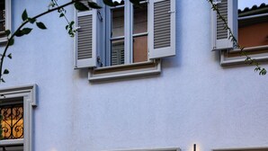A building facade with a sign reading "Stf Luxury Suites," a set of double doors, and a small set of steps leading to the entrance.