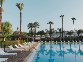 Una piscina al aire libre de temporada, tumbonas