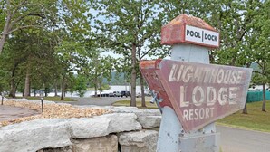 A signpost with 'Lighthouse Lodge Resort' and 'Pool Dock' labels. - Lighthouse Lodge 3 | Lakefront | Sunrise Views + Private Dock | Peaceful Cove (Kimberling City)