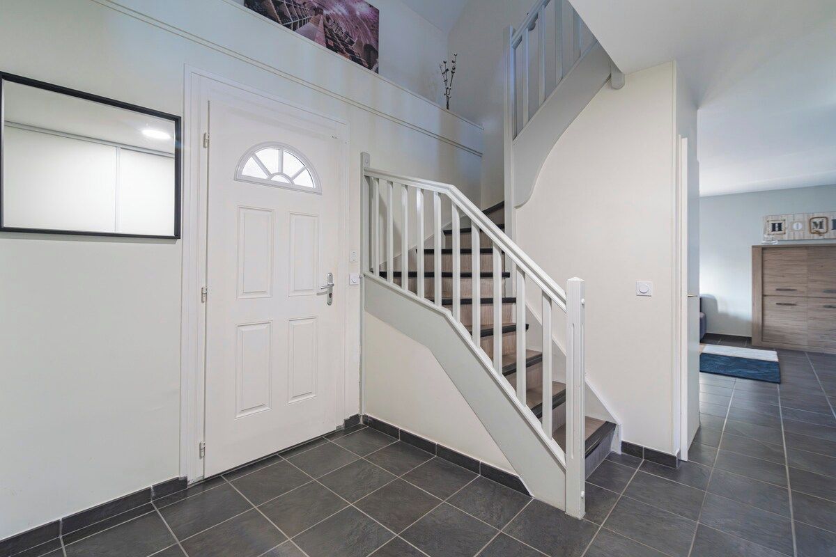A staircase with white railings leading to a landing.