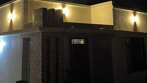 A building with a flat roof, exterior lighting, and a visible window. - Fabulous 1- self contained bedroom apartment with AC in Pwani Region (Kibaha)