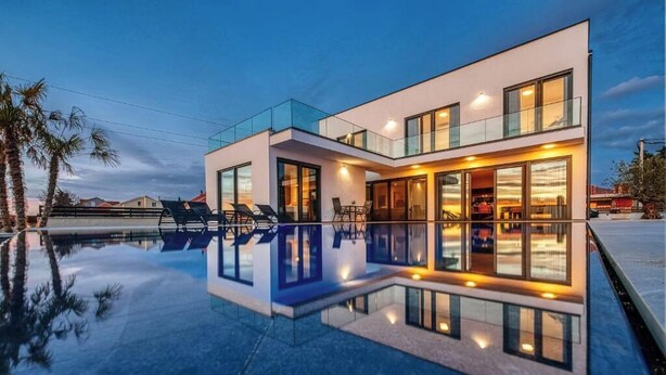 A modern two-story house with a swimming pool, large windows, and outdoor seating. - Perfect villa Stressless with beautiful pool in charming Smoković (Smoković)