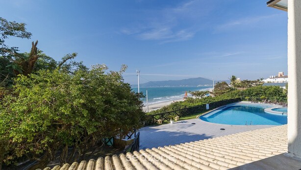 A pool area with a view of the beach and ocean. - Apt Charming Sea View in Canasvieiras Emp2201 (Florianópolis)