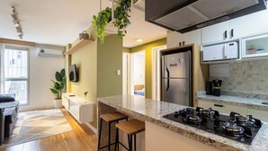 A modern kitchen with a granite countertop, stainless steel appliances, and a built-in microwave.