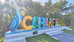 A colorful outdoor sign with the word "CABARET" and a large decorative letter 'C'.
