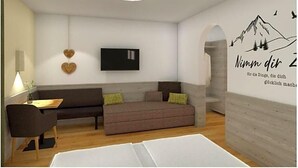 Uma sala de estar moderna com um sofá, uma mesa de centro e uma TV fixada na parede.