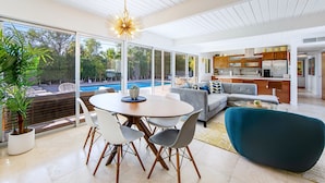A modern kitchen with wooden cabinets and a built-in oven. - Serenity in Sunmor (Palm Springs)