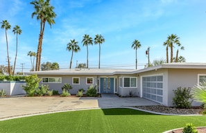 A modern two-story house with a garage, surrounded by palm trees and a well-maintained lawn. - Desert Flamingo PS (Palm Springs)