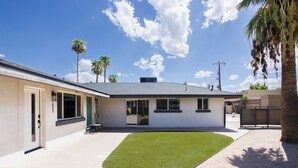 A modern two-story house with a well-maintained lawn, a garage, and a fenced backyard. - Sunrise Vista-walk to Downtown Old Town & Bars! (Scottsdale)