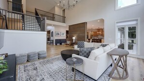 A spacious living area with a high ceiling, a staircase, a dining area, and a kitchen. - Majestic Manor-private Hundred Acre Yard-pool/spa (Lebanon)
