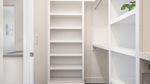 A walk-in closet with multiple shelves and a door. - Verde Heights-sleeps 12-in Cumberland Heights (Nashville)