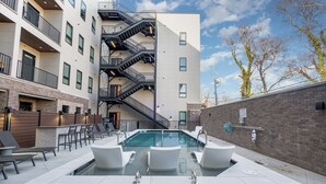 A rooftop pool with seating and a staircase leading to an upper floor. - Treble Maker -rooftop Lounge - Pool - In Music Row (Nashville)