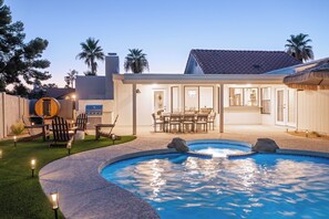 A backyard with a swimming pool, outdoor seating, and a dining area. - Solara - Pool & Spa - Sauna & Cold Plunge (Scottsdale)