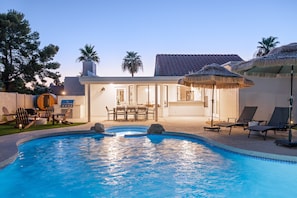 A swimming pool with lounge chairs and a barbecue area. - Solara - Pool & Spa - Sauna & Cold Plunge (Scottsdale)