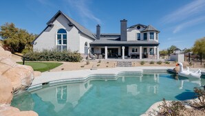 A large house with a swimming pool, a swan float, and a patio area. - Majestic Mountain Mansion-heated Pool-guest House (Paradise Valley)