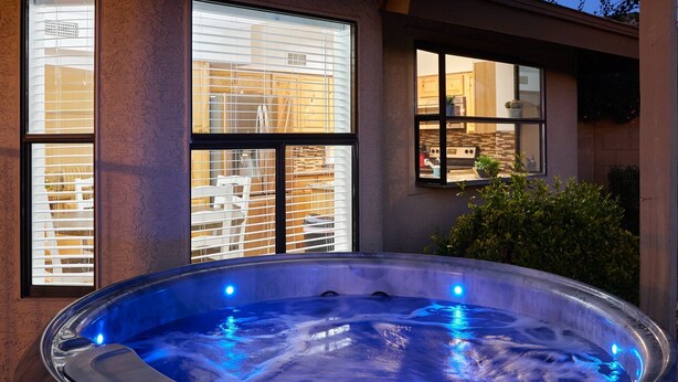A hot tub under a wooden pergola with large windows. - Sandyland-private Pool-mins 2 Waste Management TPC (Scottsdale)