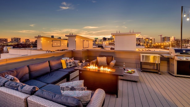 A rooftop terrace with a fire pit, outdoor seating, and a grill. - Gulch Melody - Private Rooftop - Heart of Gulch (Nashville)