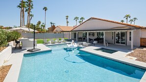 A swimming pool with a swan float, surrounded by lounge chairs and a covered patio area. - Bohemian Resort- Pool Heat Available - Golf & Games! (Scottsdale)