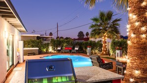 An outdoor kitchen with a built-in grill, a pool, and a palm tree. - Modern Roose-pool Heat Available-hot Tub- Old Town (Scottsdale)