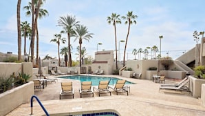 A pool area with lounge chairs, a hot tub, and palm trees. - Biltmore Bliss-pool-pickeball-gym-mountain Views (Phoenix)