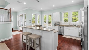 A spacious kitchen with a central island, white cabinetry, and large windows. - 🦩Book Me Baby! Grayt Escape Private Home at The Preserve🦩 (Santa Rosa Beach)