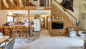 L’intérieur d’une cabane comprend une cuisine, un coin repas et un escalier menant à une mezzanine.