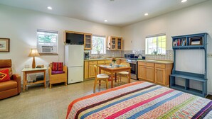 A compact living space with a kitchenette, a dining area, a sofa, and a bed. - Fish, Raft & Hike: Southwest OR Couple’s Retreat! (Trail)