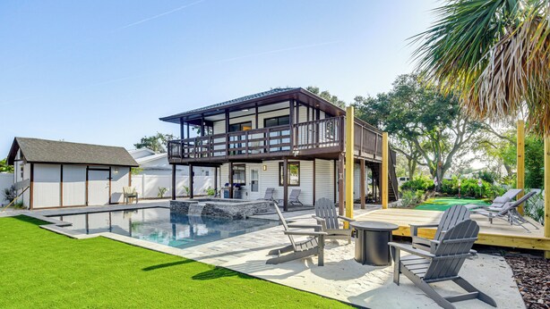 A modern house with a large deck, a swimming pool, and outdoor seating. - Outdoor Oasis w/ Boat Slip & Spa in St Augustine! (St. Augustine)