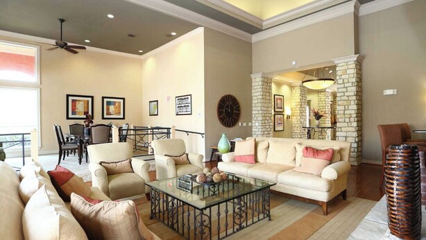 A spacious living room with a large sofa, a coffee table, and a dining area with chairs and a table. - Landing | Beautiful 1BD, Pool, Gym (Fort Worth)