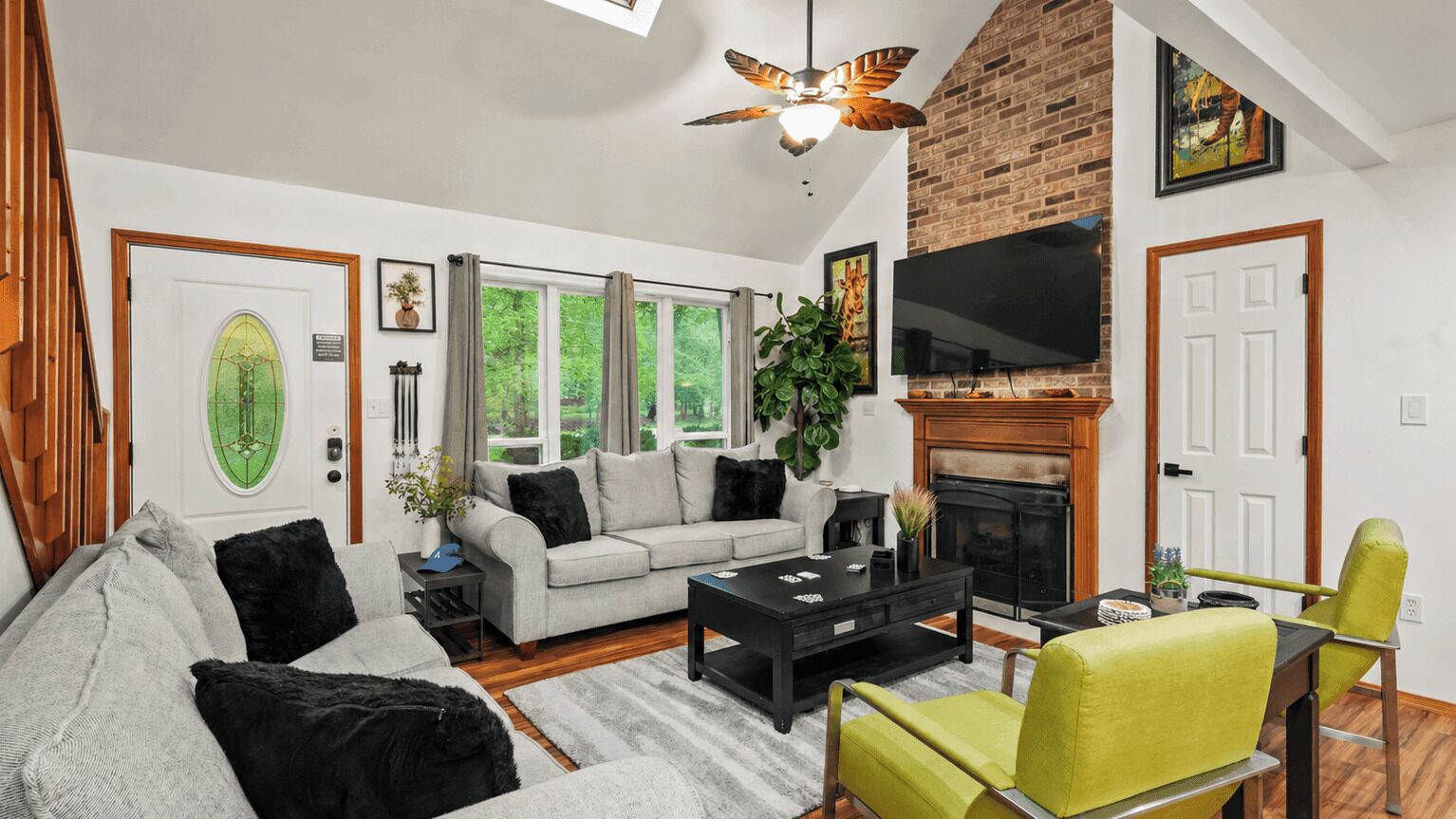 A living room with a fireplace, a sofa, a coffee table, and a television.