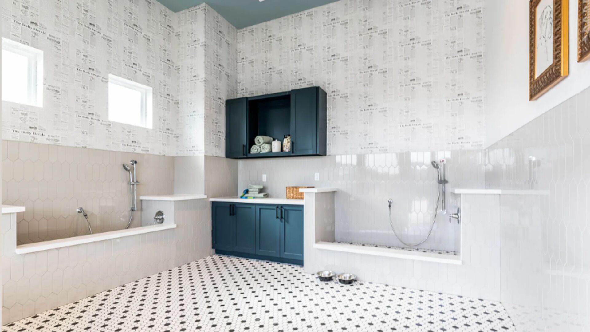 A bathroom with a black and white patterned floor, a built-in sink, a bathtub, and a shower area.