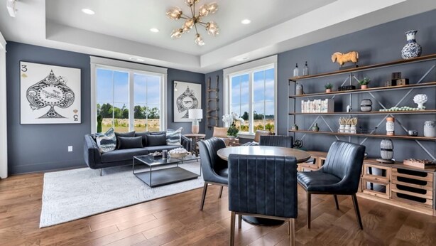 A modern living room with a sofa, chairs, a coffee table, and a bookshelf. - Landing | Chic 1BD, Gym, Pool (Huntsville)