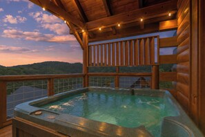 A hot tub on a wooden deck with a view of a forested hill. - OMG VIEWS! Gameroom~Hot tub~Outdoor Pool~ Suana (Sevierville)
