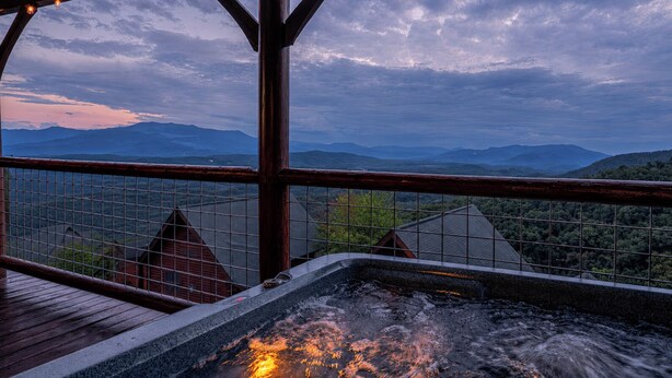 A hot tub with a view of mountains and a wooden deck. - OMG VIEWS! Gameroom~Hot tub~Outdoor Pool~ Suana (Sevierville)