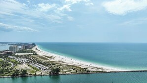 A coastal cityscape with a wide beach, a marina, and high-rise buildings. - Beachfront Condo w/ Pool & Balcony Sunset Views (Clearwater)