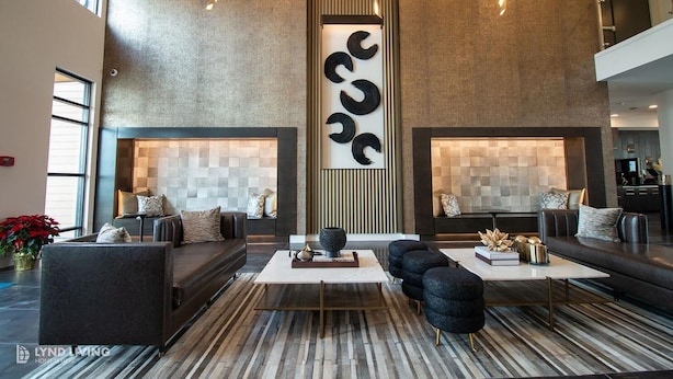 A modern living room with sofas, a coffee table, and decorative wall art. - Landing | Chic 2BD, Pool, Clubhouse (San Antonio)