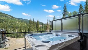 A hot tub on an outdoor deck with a mountain view. - Lumi | Slope-Side | Pvt Hot Tub | Resort Access (Panorama)