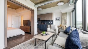 A modern apartment with a bedroom, living room, and kitchen.